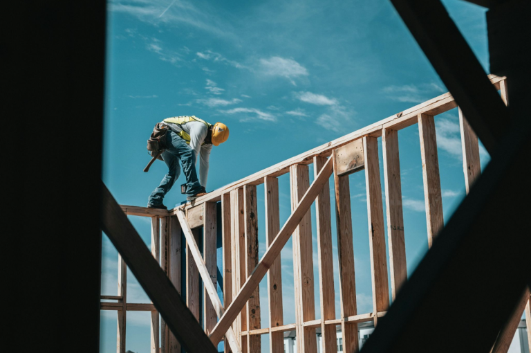 A general contractor framing a house.