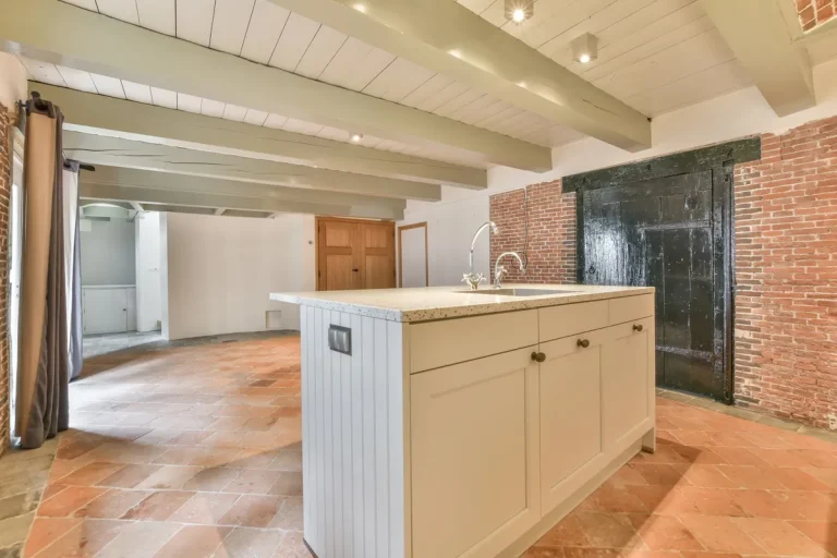 A cozy rustic farmhouse kitchen featuring wooden cabinets and a large island, ideal for remodeling inspiration.